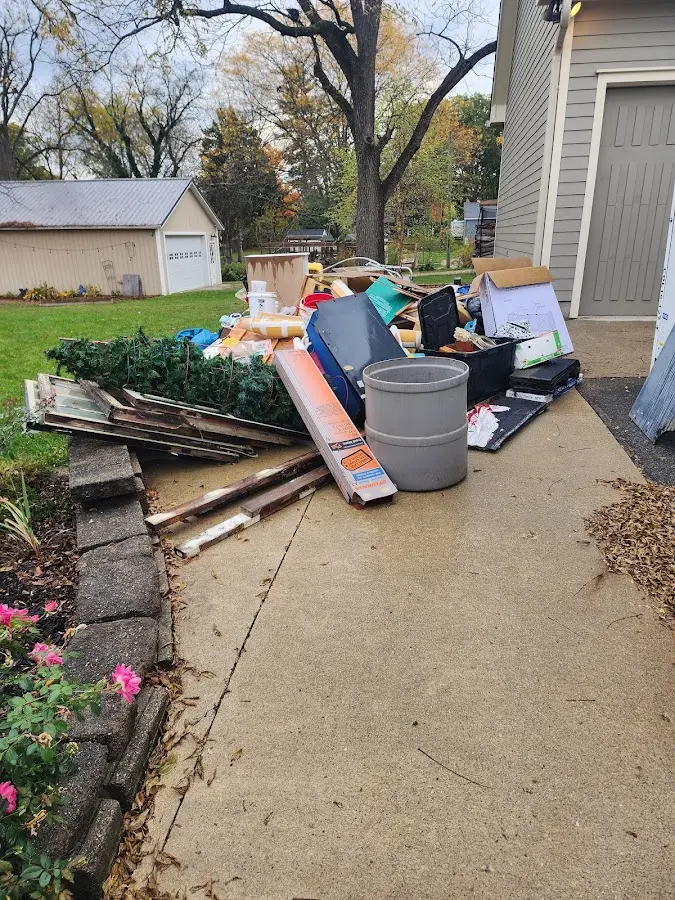 Dumpster being loaded with debris for 10 Yard Dumpster Rental in Madison
